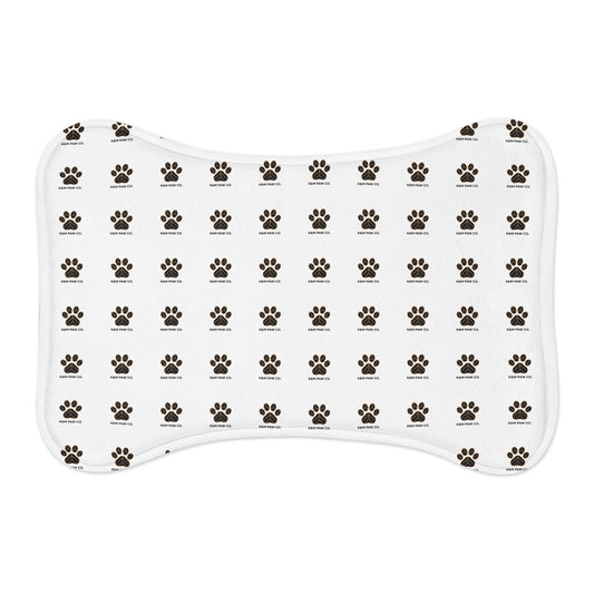 White dog mat with repeating black and gold paw print pattern and K&M Paw Co. logo, designed for pet owners seeking stylish, high-quality, and functional accessories